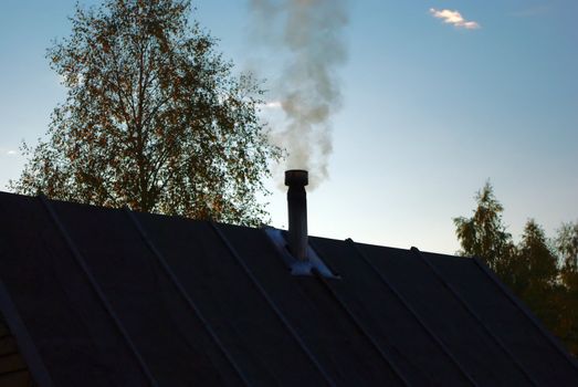 Warming the Sauna in the Evening on Countryside