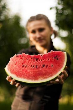 young girl offers juicy red watermelon taste