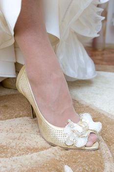 a white shoe with a beautiful bow