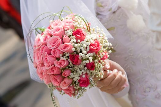 bride, wedding dress and flower bouquet