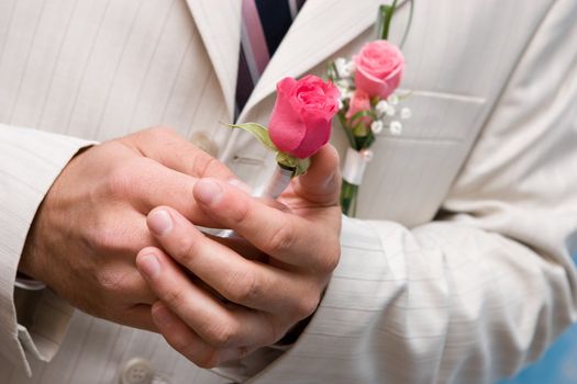 Man holds in hands a small bouquet from roses