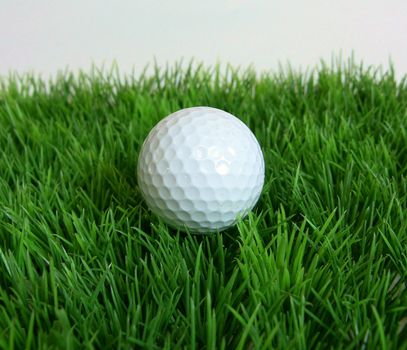 photo of a golfball and grass