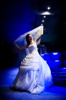 beautiful bride under the blue light of the lamp