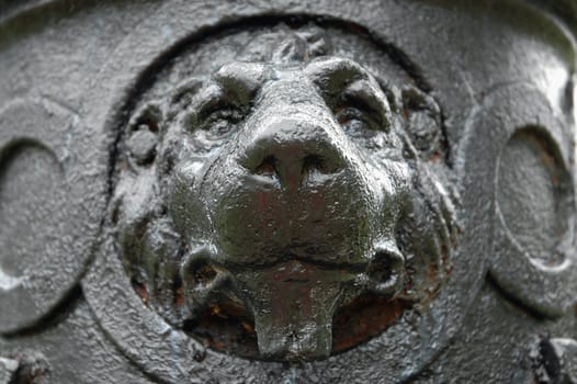 Detail image of a lion's head from an old cast-iron lamp post.