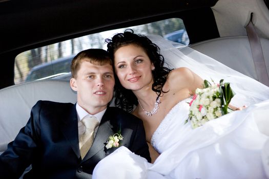 happy bride and groom in the car