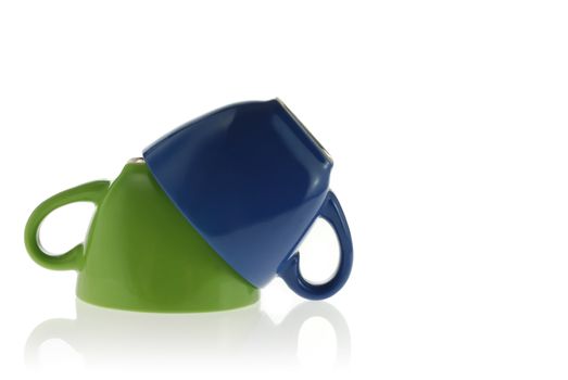 Two cups. Green and dark blue color turned to top a bottom