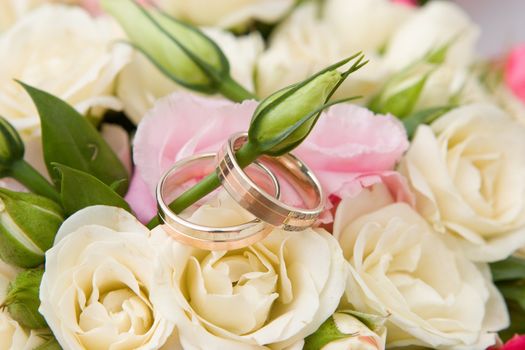gold rings and rose bouquet