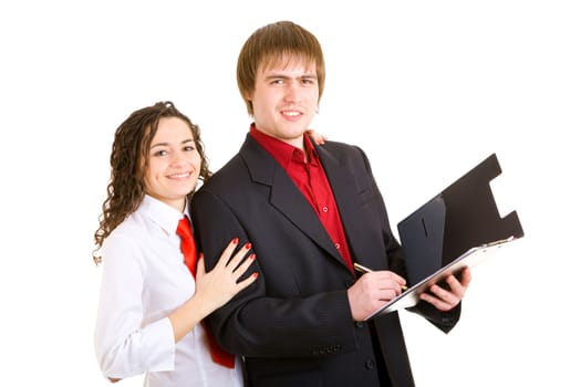 smiling man and woman dressed for office stand with carpet