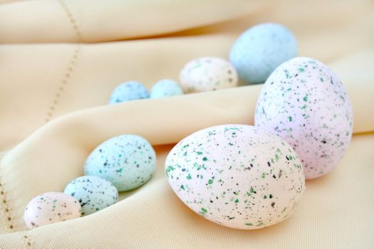 Colorful Easter eggs on a cloth background.