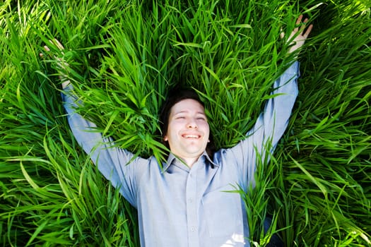 businessman rest on the green grass