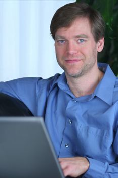 Handsome business man working on laptop