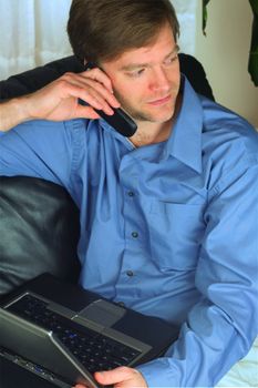 Handsome business man working on laptop