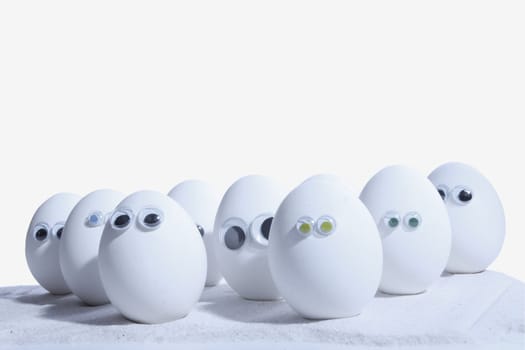 Eggs with eyeballs, lined up in row, Egg people. Add your own expressions