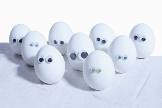 Eggs with eyeballs, lined up in row, Egg people. Add your own expressions