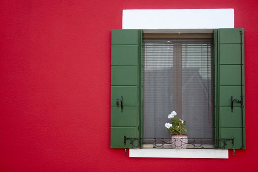 Bright red window frame in the Venetian town of Burano