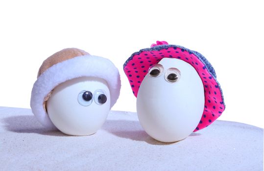 Two hardboiled eggs with eyeballs and hats, add your own expressions,