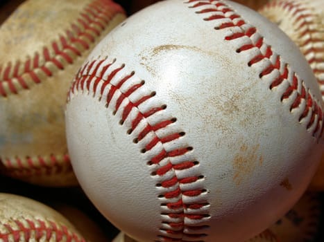 Old baseballs in a bucket after long season