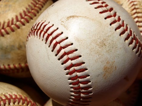 Old baseballs in a bucket after long season