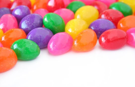 Colorful jelly beans on a white background with copy space.