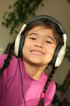 Six year old listening to music with headphones