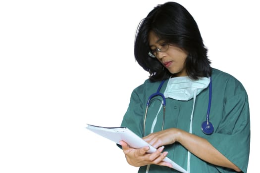 Nurse in scrubs checking notes