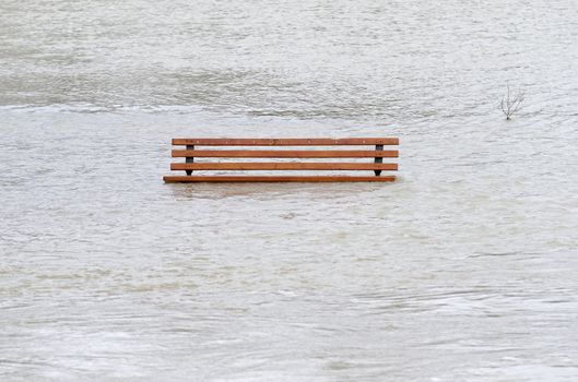 a  park bench surrounded by water