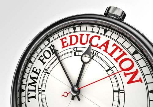 time for education concept clock closeup on white background with red and black words