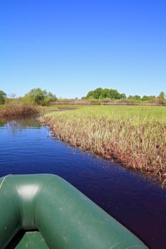 green boat on small river