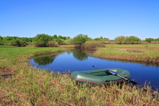 green boat on small river
