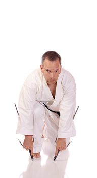 Man in karate-gi with two sai in his hands
