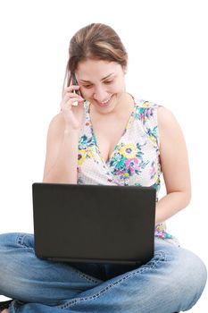 A pretty young woman sitting on floor with laptop and mobile phone