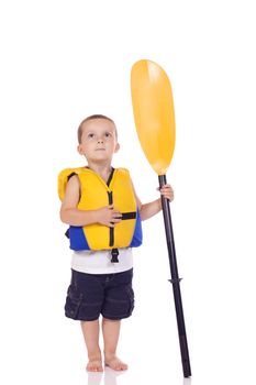 Cute little boy with a life jacket and a paddle