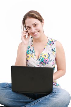 beautiful young woman talking over the phone and using laptop