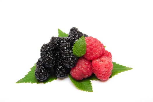 heap of ripe raspberries with leaves 