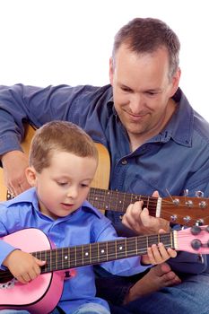 Father and son holding their guitar