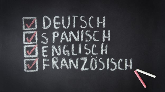 Chalk drawing of English, German, Spanish, French check list.