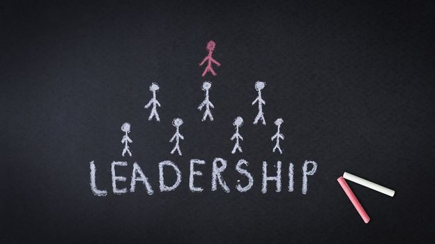 Leadership chalk drawing illustration on dark background.