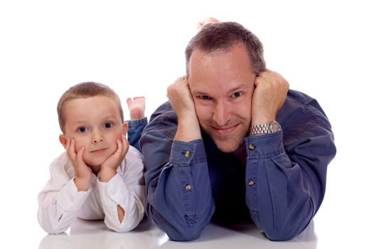 Father and son laying on their stomach