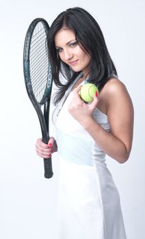 Portrait of a young and beautiful girl in tennis in the form of a racket and a ball in his hands