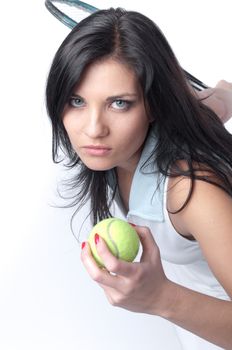 Portrait of a young and beautiful girl in tennis in the form of a racket and a ball in his hands