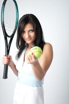 Portrait of a young and beautiful girl in tennis in the form of a racket and a ball in his hands