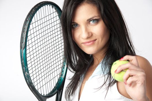 Portrait of a young and beautiful girl in tennis in the form of a racket and a ball in his hands