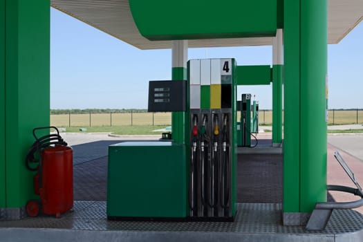 A gas station pumps with car