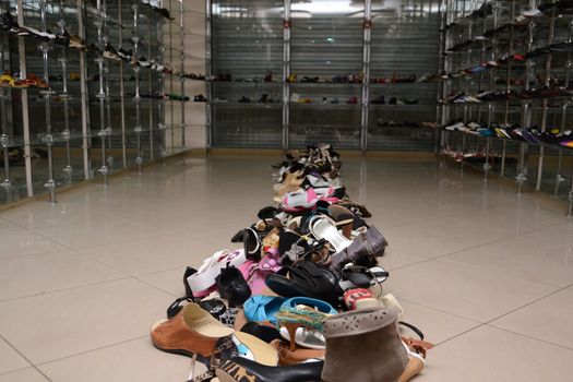 Pile of various female and male shoes in a store