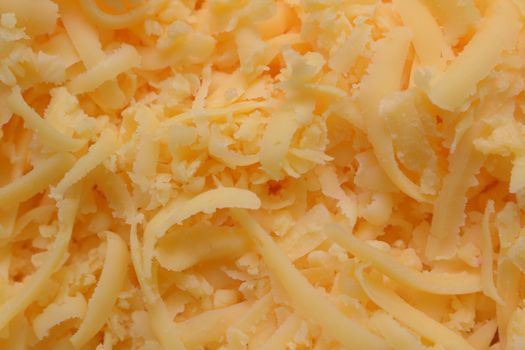 Grated pizza cheese close up texture