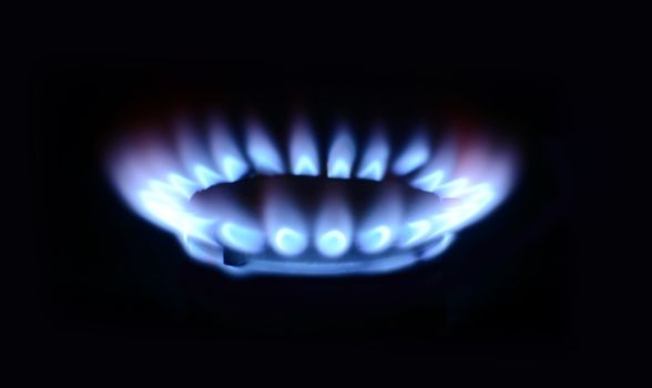 blue flame of gas on a black background