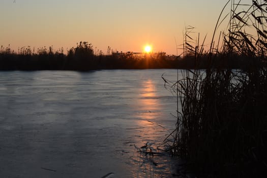 Frozen lake at sunset (sunrise)