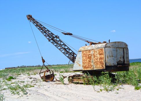 Excavator on a background of sand