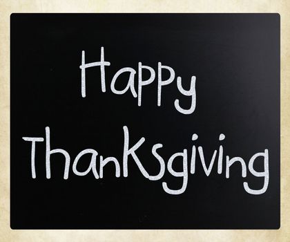 "Happy Thanksgiving" handwritten with white chalk on a blackboard