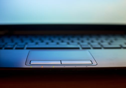 close up of laptop keyboard as a background toned to blue 